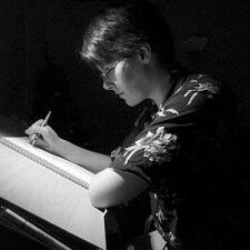 An image of a woman at a drawing board, in monochrome